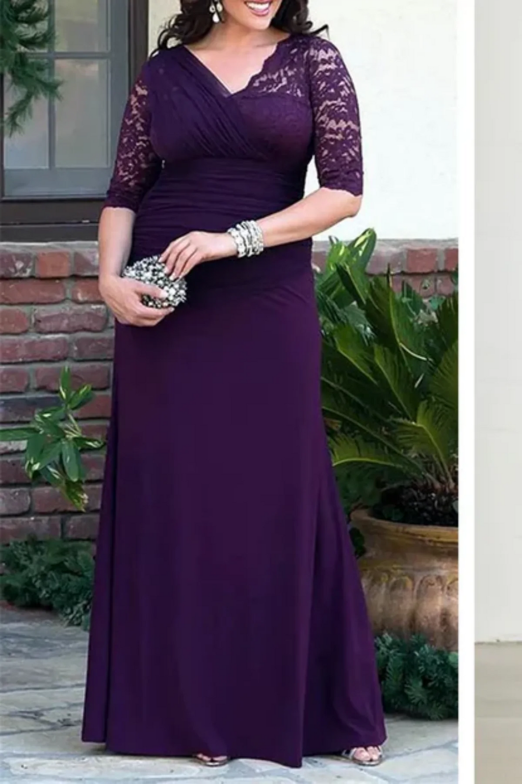Plum mother of the bride gown with lace sleeves, draped chiffon bodice, and floor-length skirt from real wedding party
