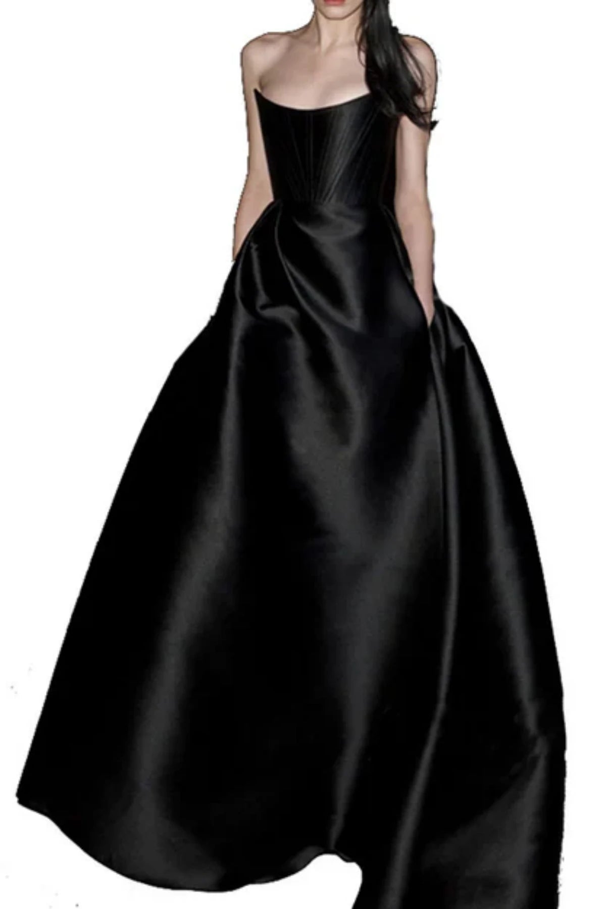 Studio portrait of a model wearing a strapless black satin bridal dress with an inverted scoop neckline, structured boning on the bodice, and functional side pockets