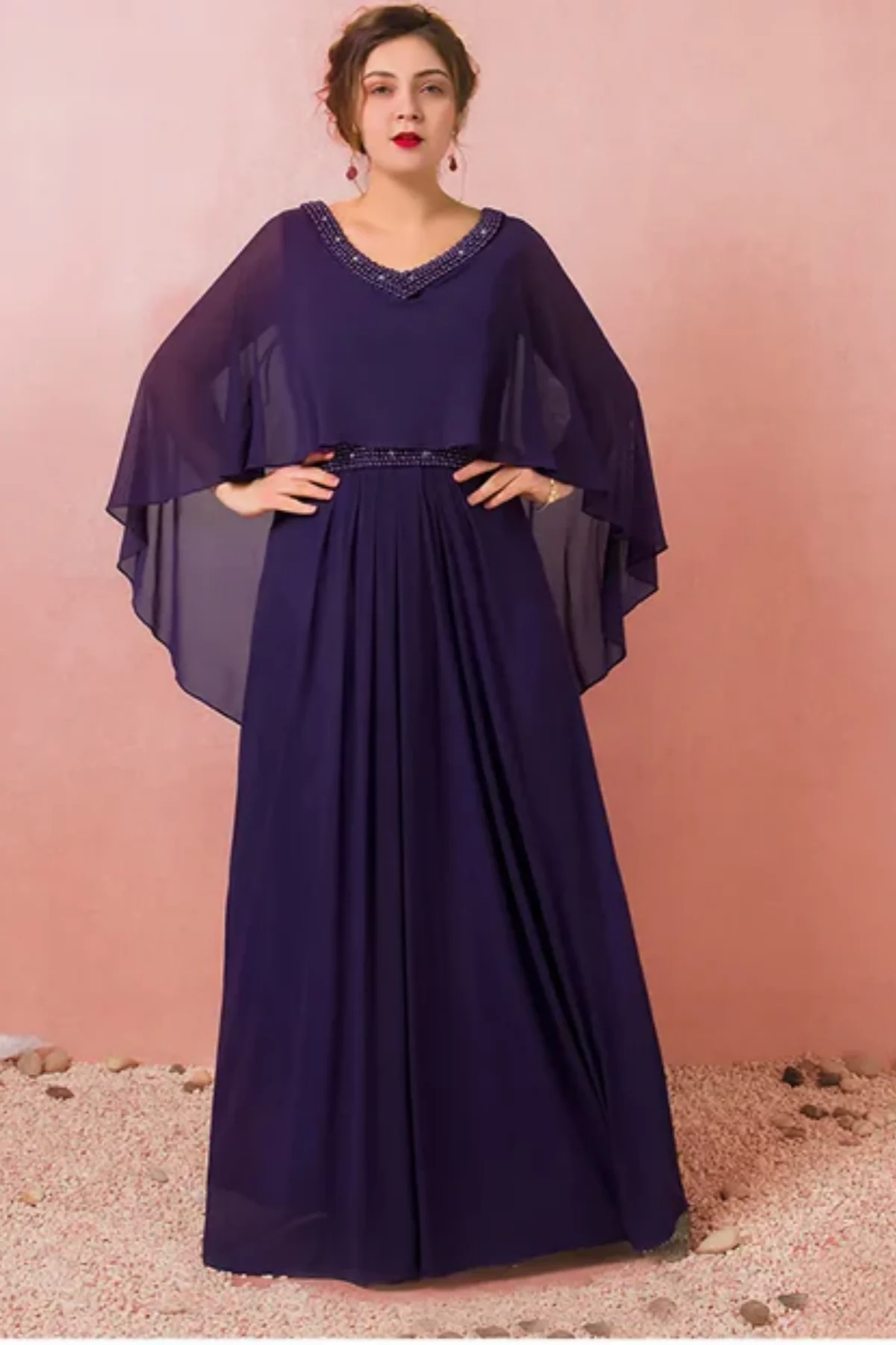 Full-length navy blue mother of the bride dress featuring a beaded scoop neckline, cape-style chiffon sleeves, and elegant floor-length silhouette on mannequin