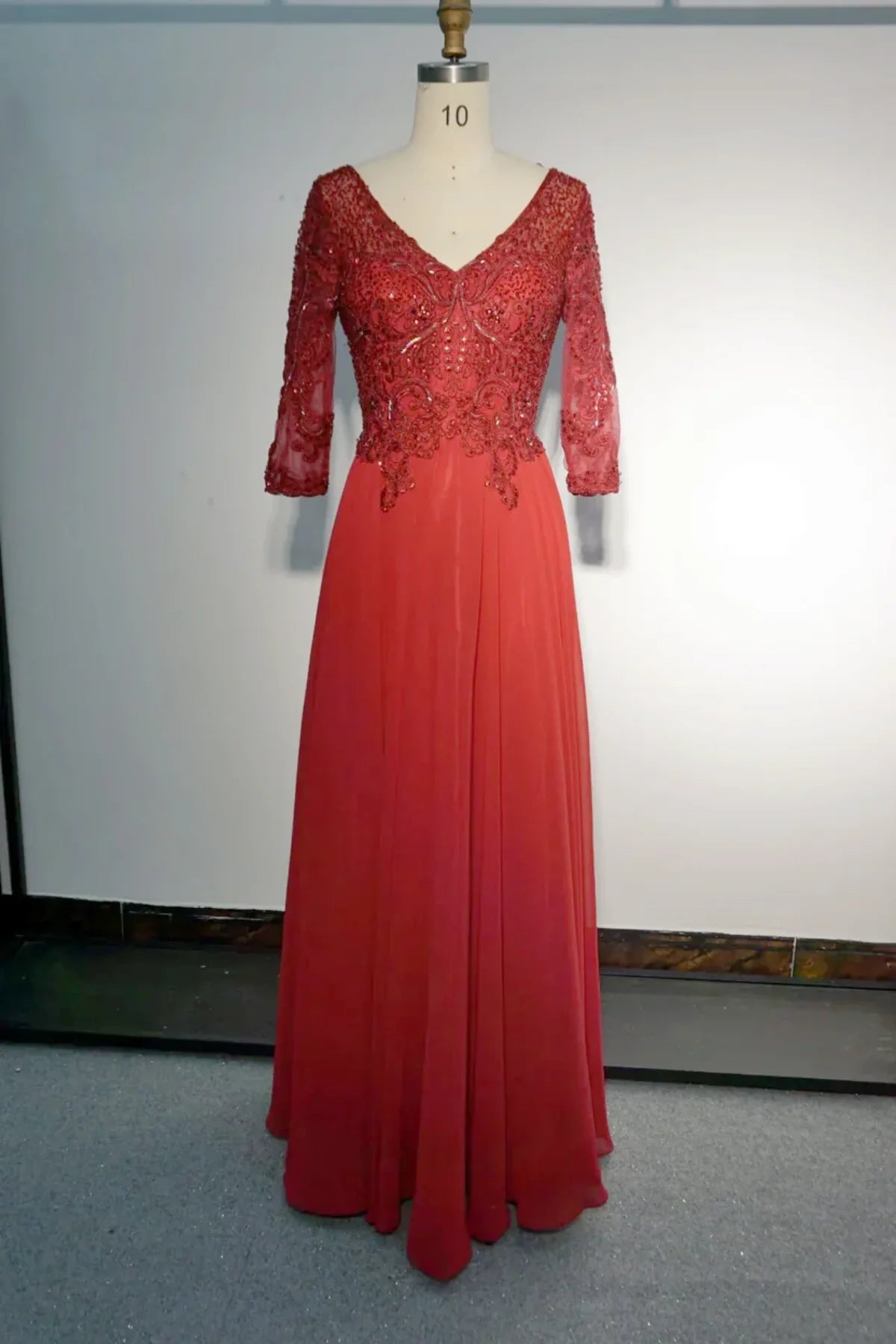 Red mother of the bride dress with V-neck lace bodice, beaded details, 3/4 sleeves, and A-line chiffon skirt, flattering formal gown