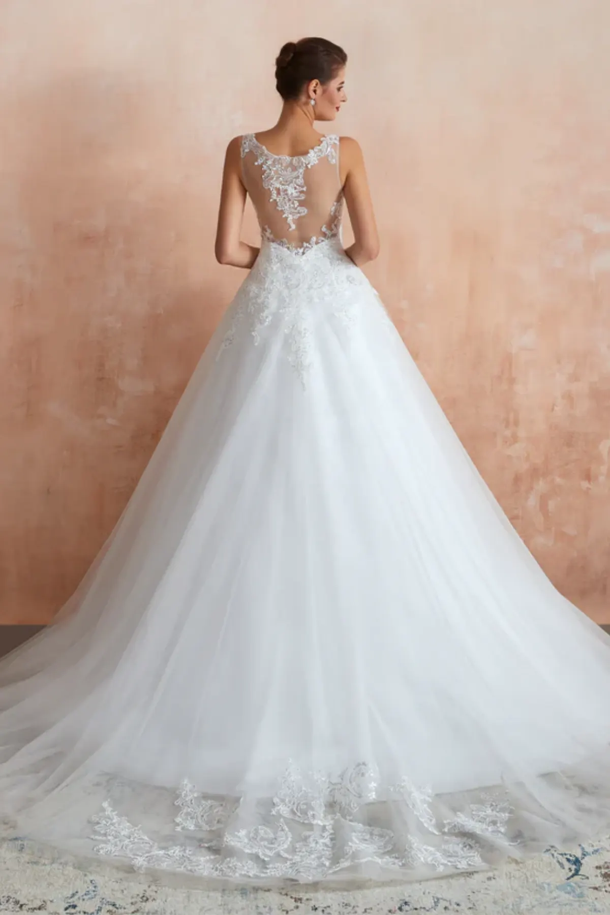 Elegant A-line bridal gown with lace train, sheer back and flowing tulle skirt full back view