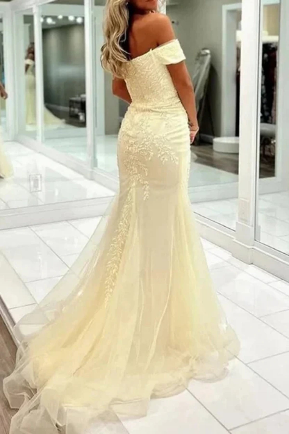 flattering pastel yellow appliqued prom dress with fit and flare silhouette