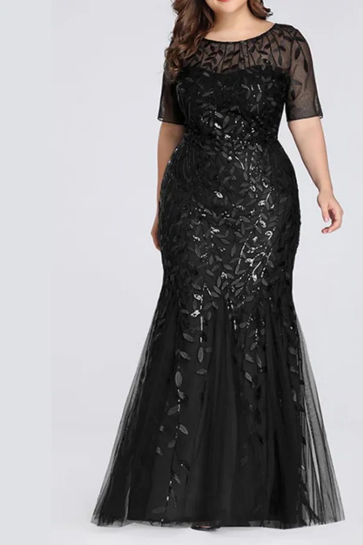 ull front view of a black long-sleeve mermaid wedding dress with an illusion V-neckline, covered in textured white leaf embroidery and sequins