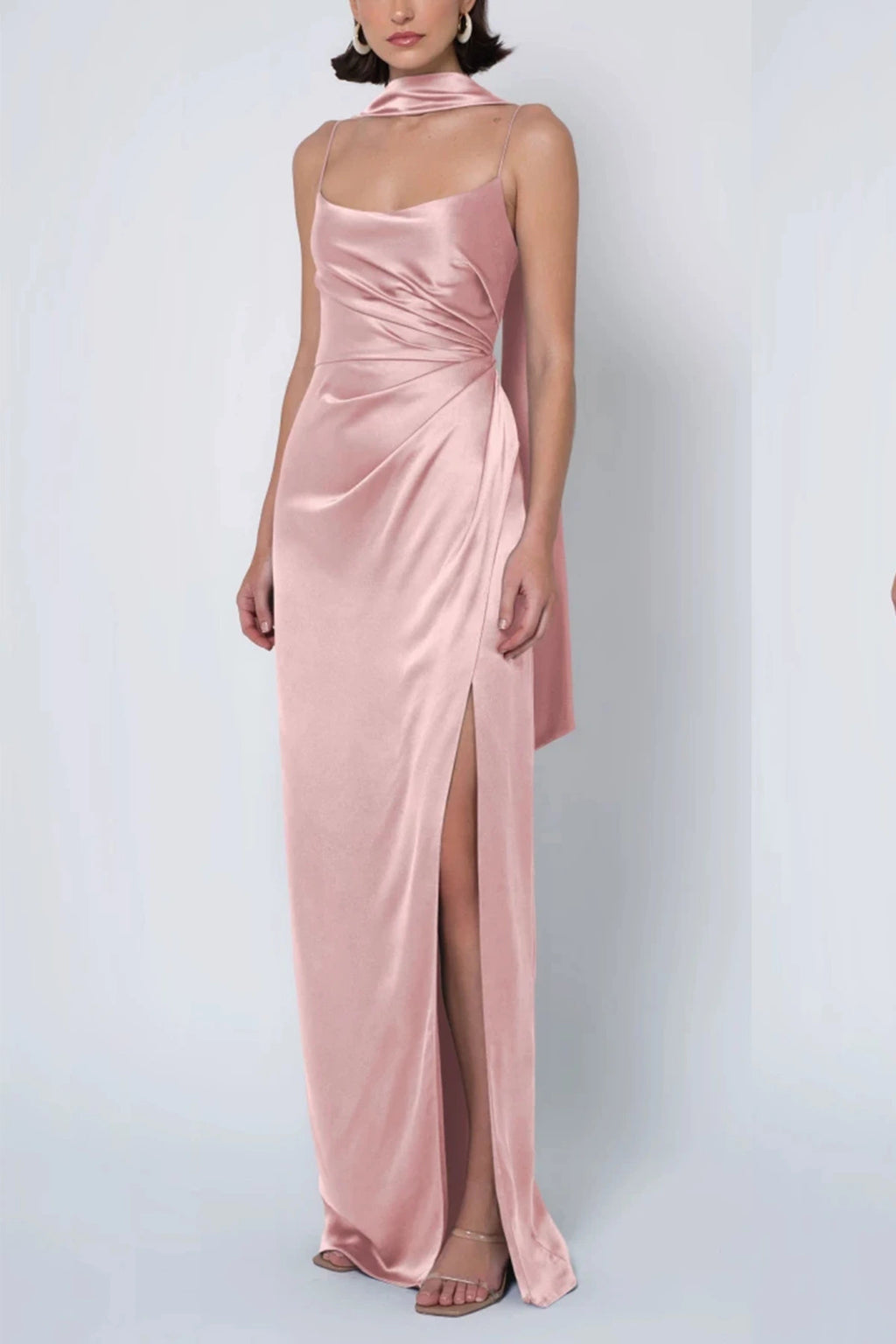 a dusty blush pink satin bridesmaid dress with a cowl neck, draped waist, matching neck scarf, and high leg slit