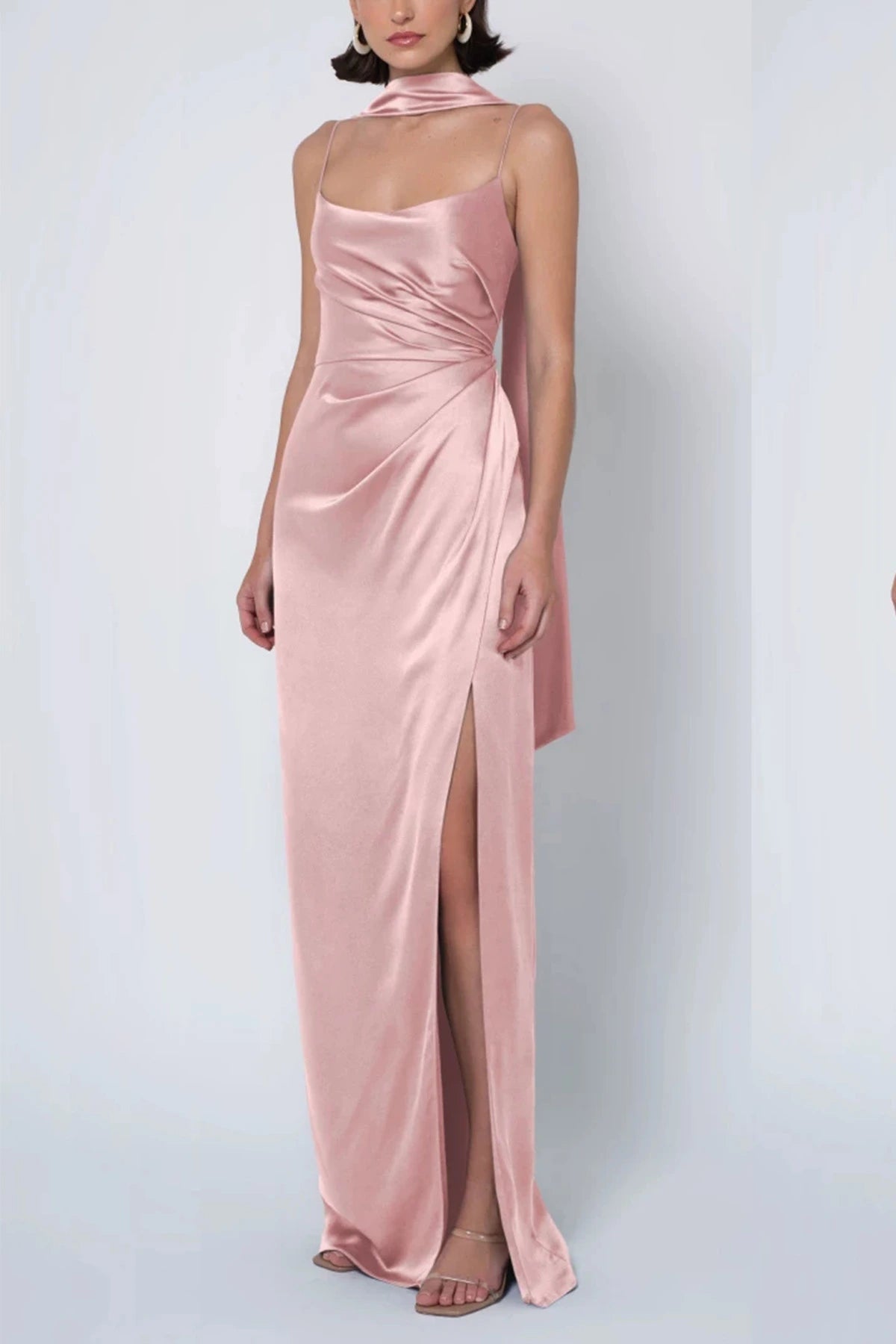 a dusty blush pink satin bridesmaid dress with a cowl neck, draped waist, matching neck scarf, and high leg slit