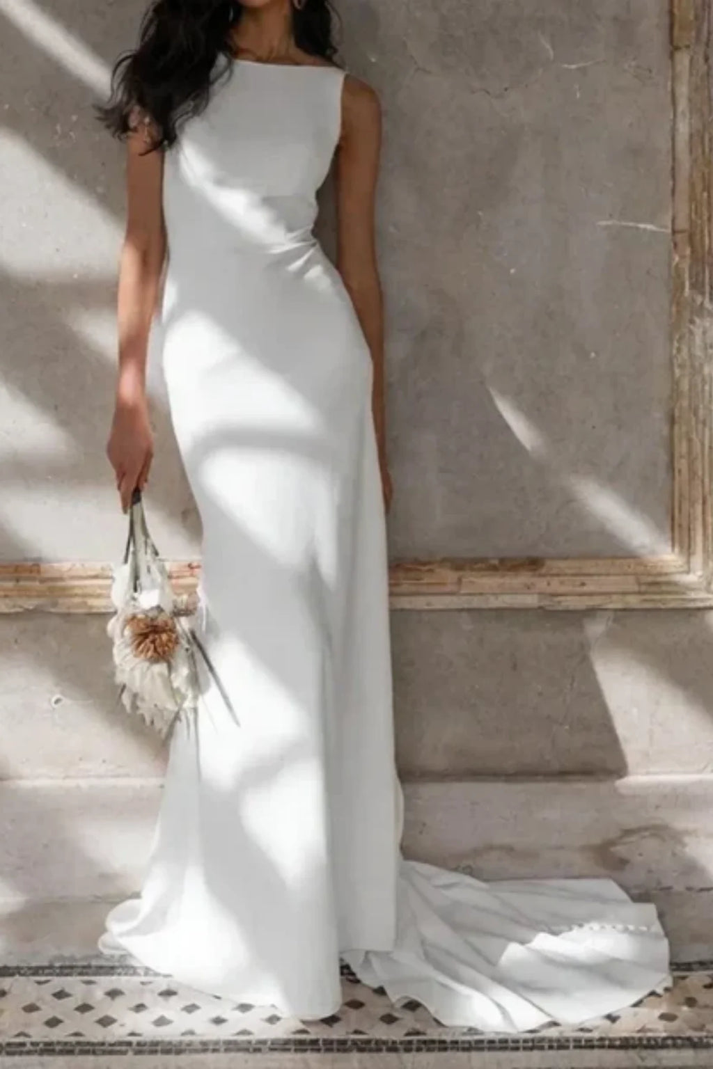 Bride wearing minimalist sheath wedding dress in natural light setting