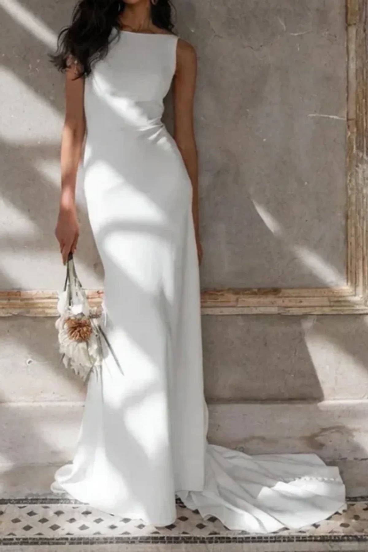 Bride wearing minimalist sheath wedding dress in natural light setting