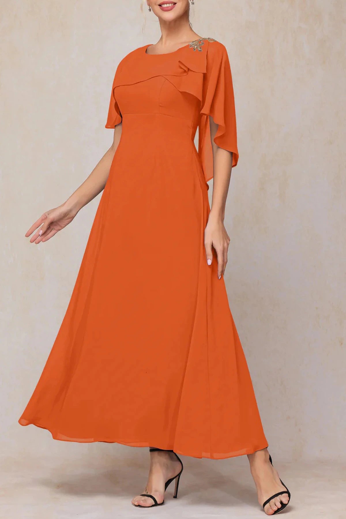 Burnt orange chiffon mother of the bride dress with cape sleeves