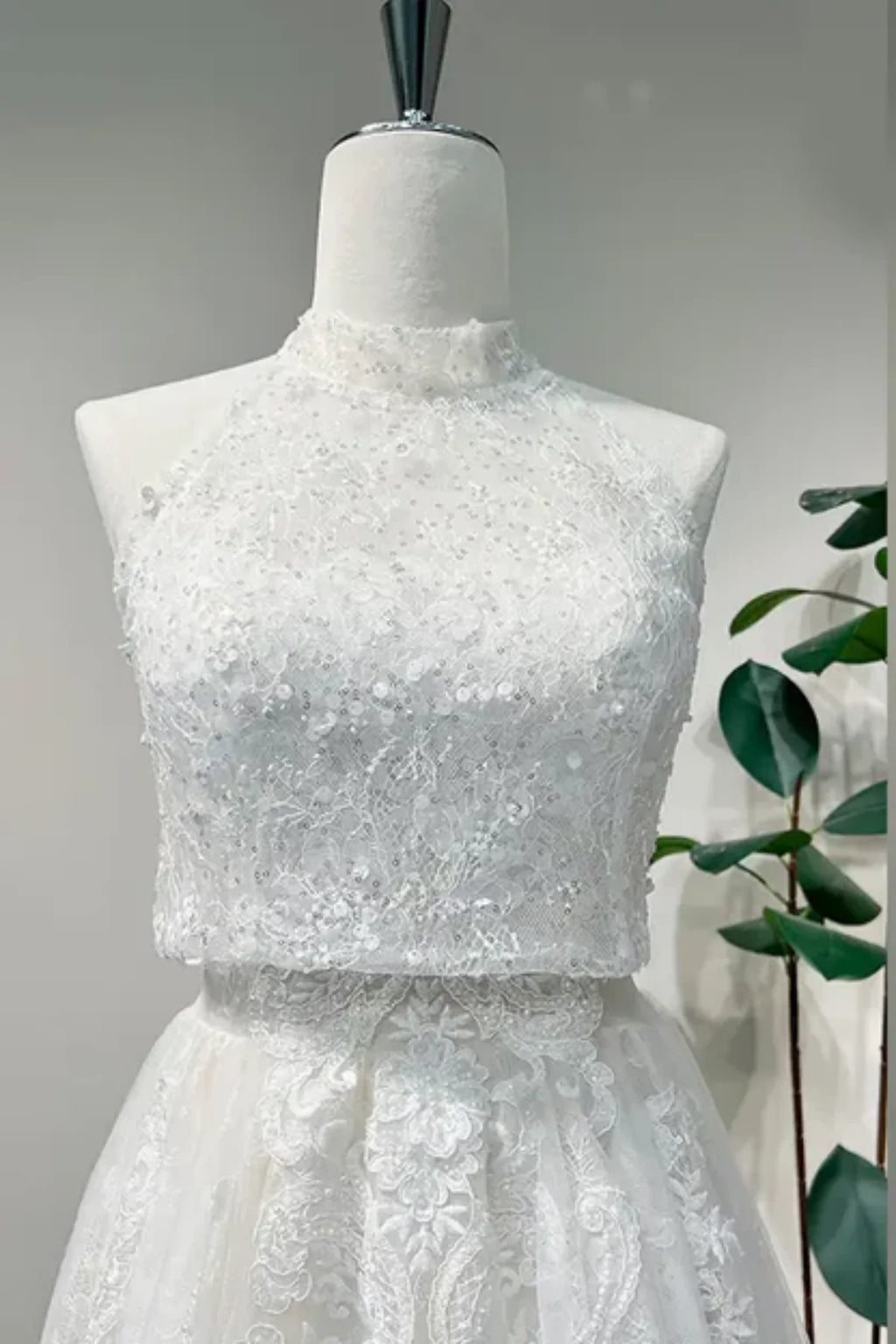 Close-up of detachable high neck lace overlay with beading on convertible wedding dress bodice