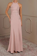 Close-up of the bodice on a pastel pink evening gown, highlighting the intricate silver beadwork along the halter neck and floral lace appliqués