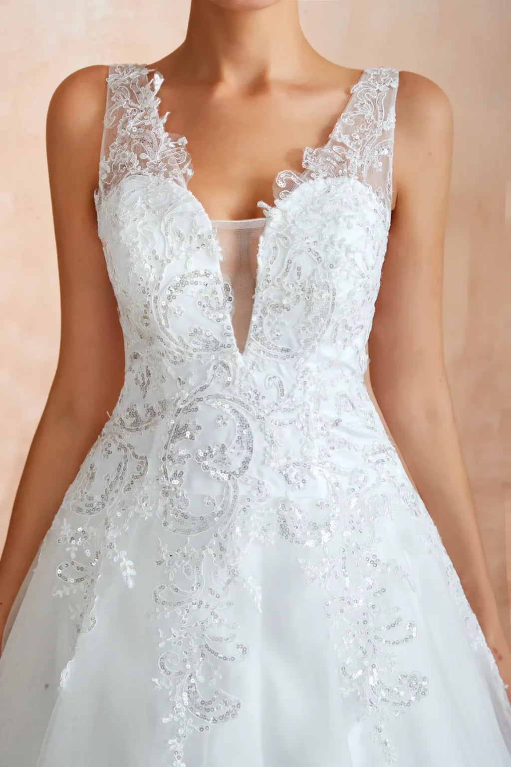 sequined white wedding dress with plunging sheer v-neck and wide straps
