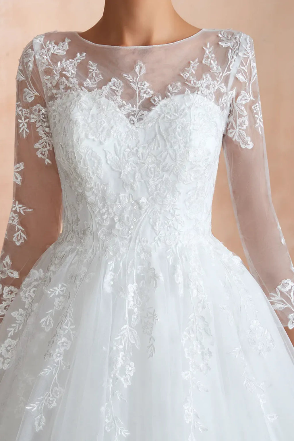 Close-up of lace long sleeve wedding dress bodice with floral embroidery and illusion neckline