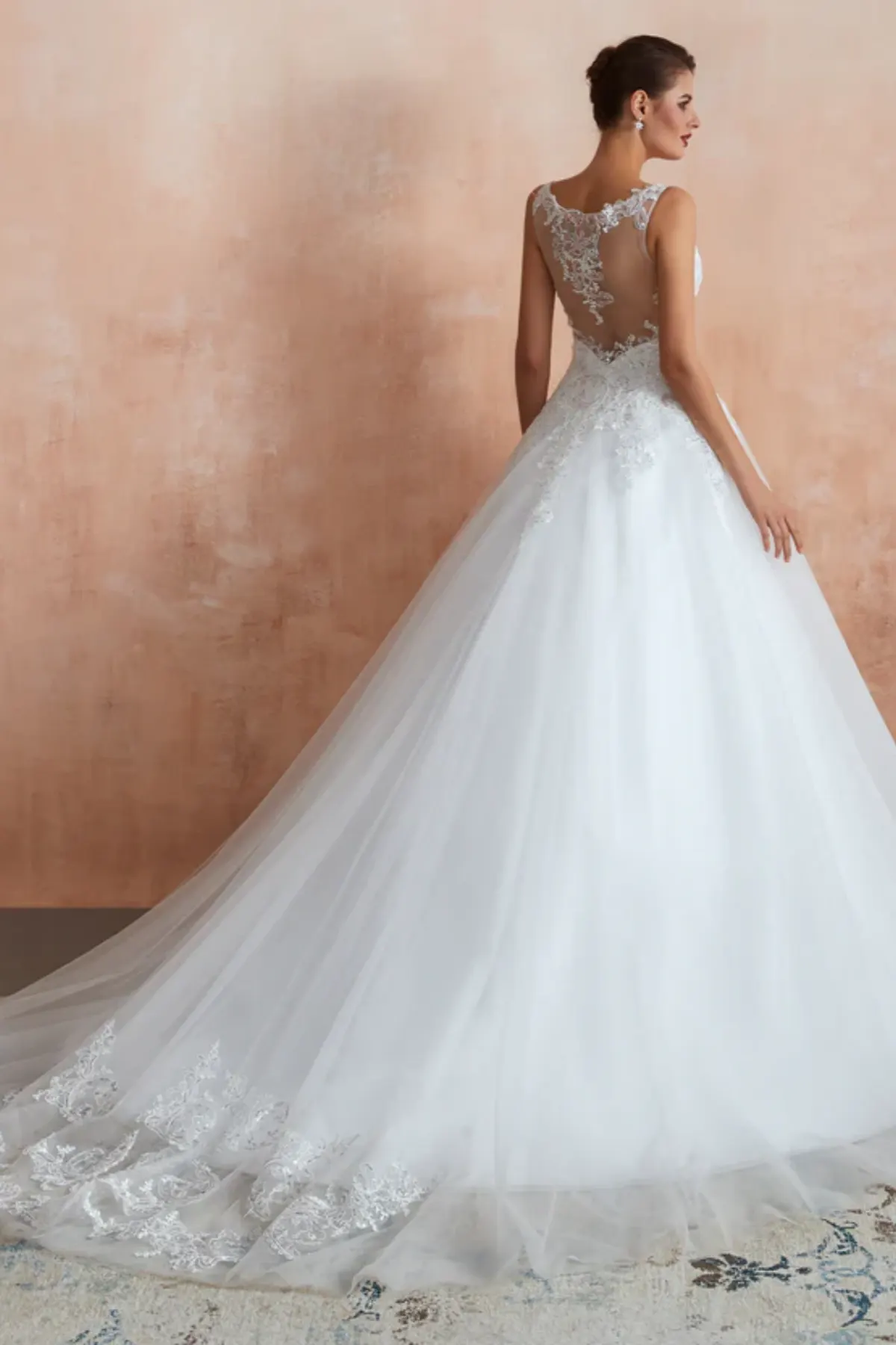 Wedding dress with illusion lace back, sheer panel and floral appliqué detailing with long train back view