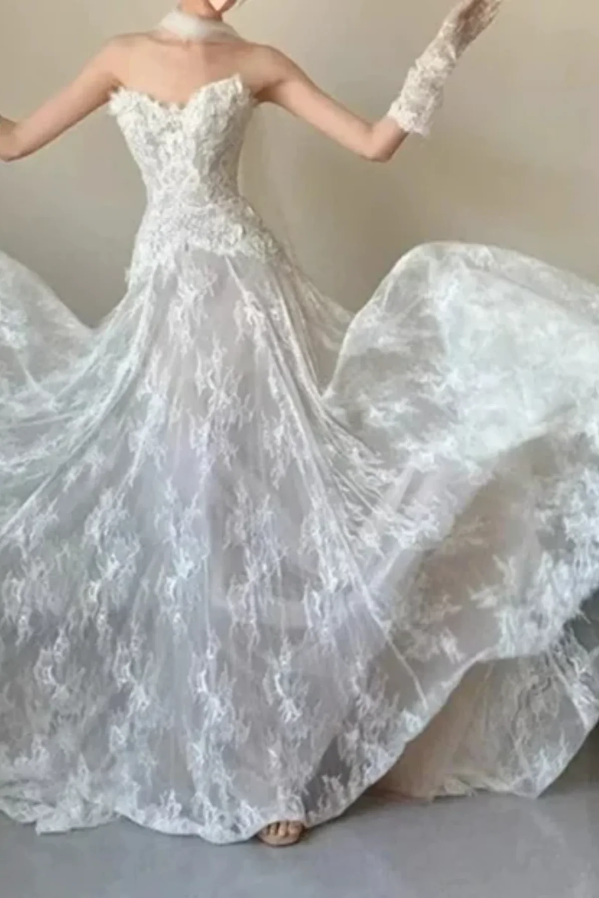 Full-length front view of an ivory floral lace wedding dress with a subtle champagne underlay, featuring textured 3D lace details on the sweetheart bodice