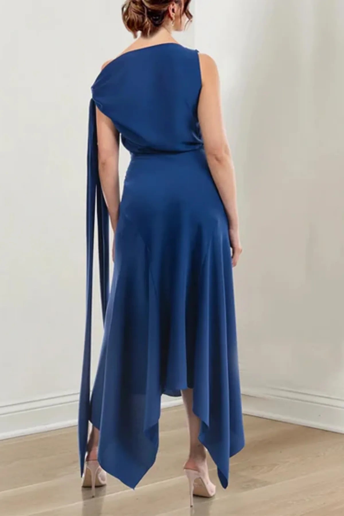 Full back view of a floor-length navy chiffon evening gown on a mannequin, featuring a clean jewel neck design and a flowing draped skirt