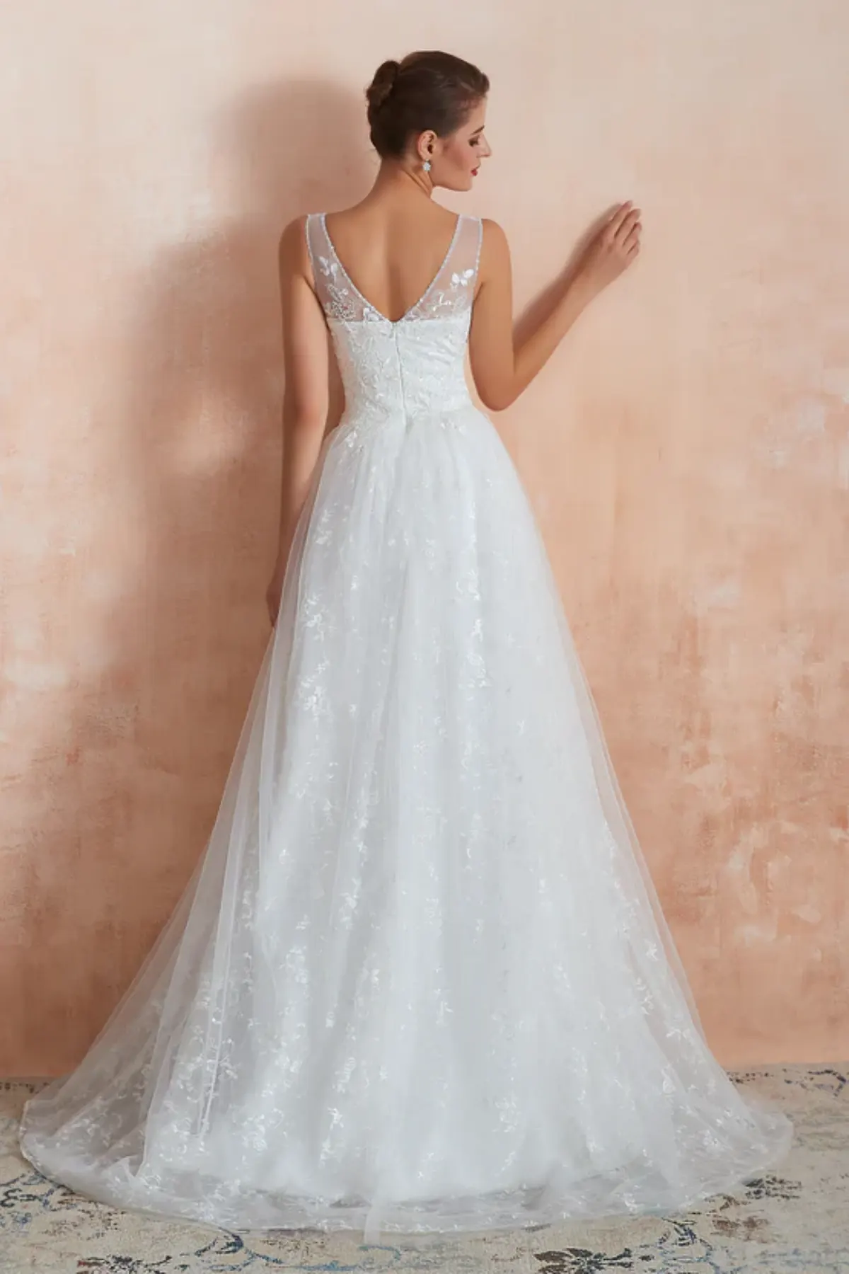 Back view of A-line wedding dress with lace bodice and flowing tulle train