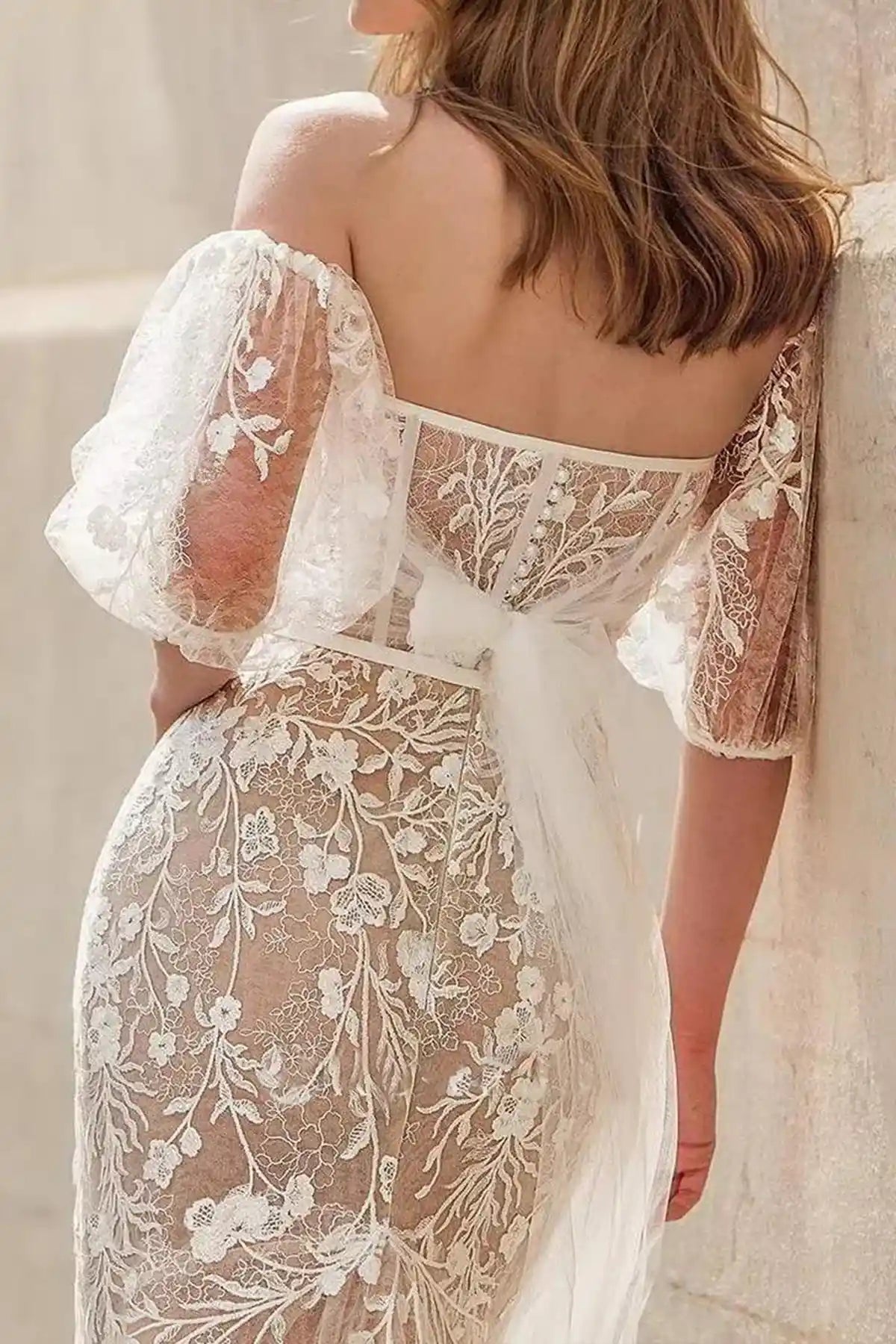 Studio display of the nude underlay lace mermaid gown on a mannequin, showcasing the crisp detail of the botanical embroidery and strapless corset configuration