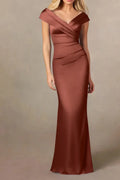 Full-length front view of an auburn satin mother of the bride dress on a mannequin, showcasing a pleated off-the-shoulder portrait neckline and a tailored mermaid silhouette