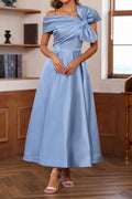 Front view of a steel blue satin mother of the bride dress on a mannequin, featuring a pleated off-the-shoulder bodice and a large detachable bowknot at the waist