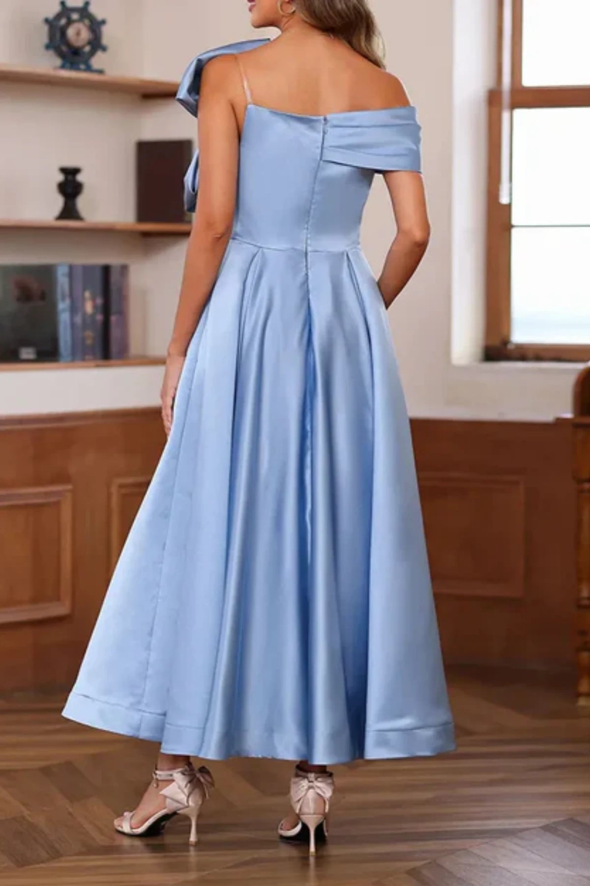 Full-length front view of a steel blue satin tea-length mother of the groom dress, displaying an off-the-shoulder sweetheart neck and a flared A-line skirt