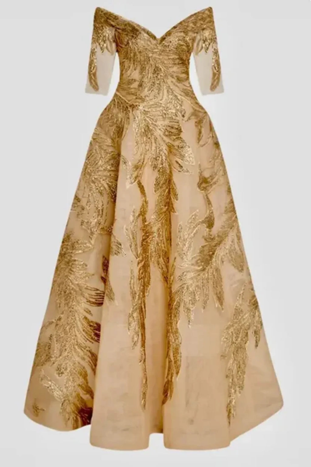 Full-length front view of a champagne gold mother of the bride gown on a mannequin, featuring an off-the-shoulder portrait collar, elbow-length sleeves, and shimmering feather-patterned metallic embroidery
