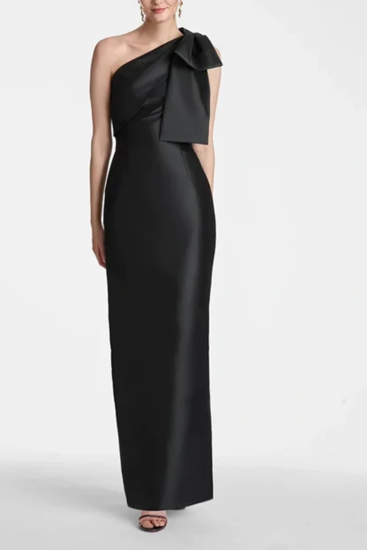 Full-length front view of a black satin mother of the bride gown on a mannequin, showcasing a one-shoulder neckline adorned with structured accent bows and a sleek column skirt