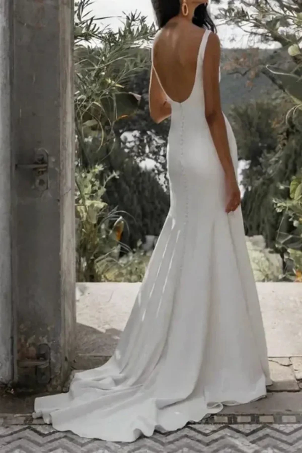 Open back minimalist wedding dress in outdoor garden setting