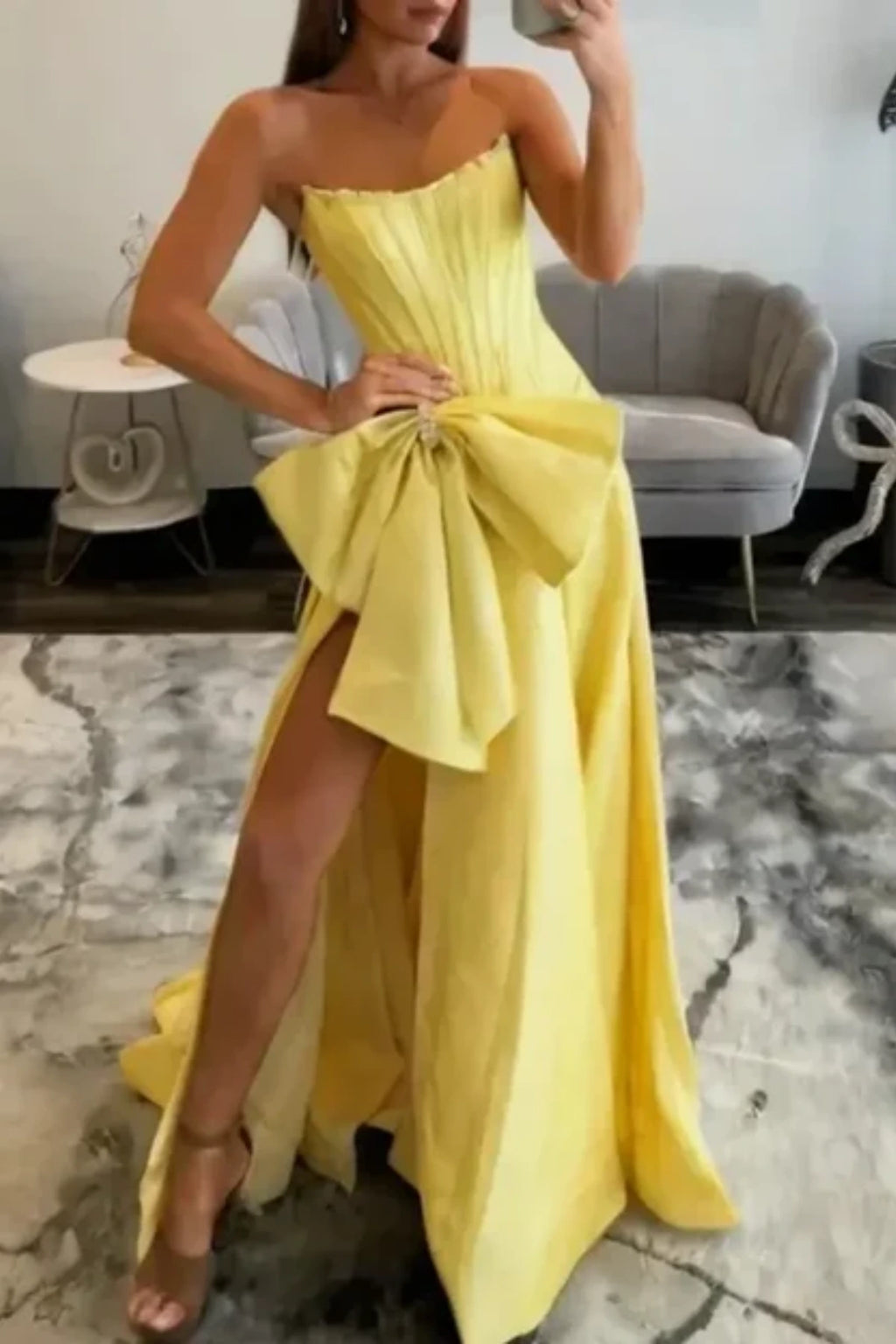 yellow satin prom dress with structured bodice and big bowknot detail