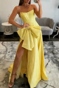 yellow satin prom dress with structured bodice and big bowknot detail