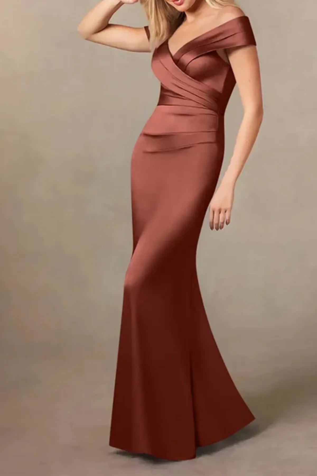 front view of a rust-toned satin mother of the groom dress, highlighting the elegant flare of the mermaid skirt