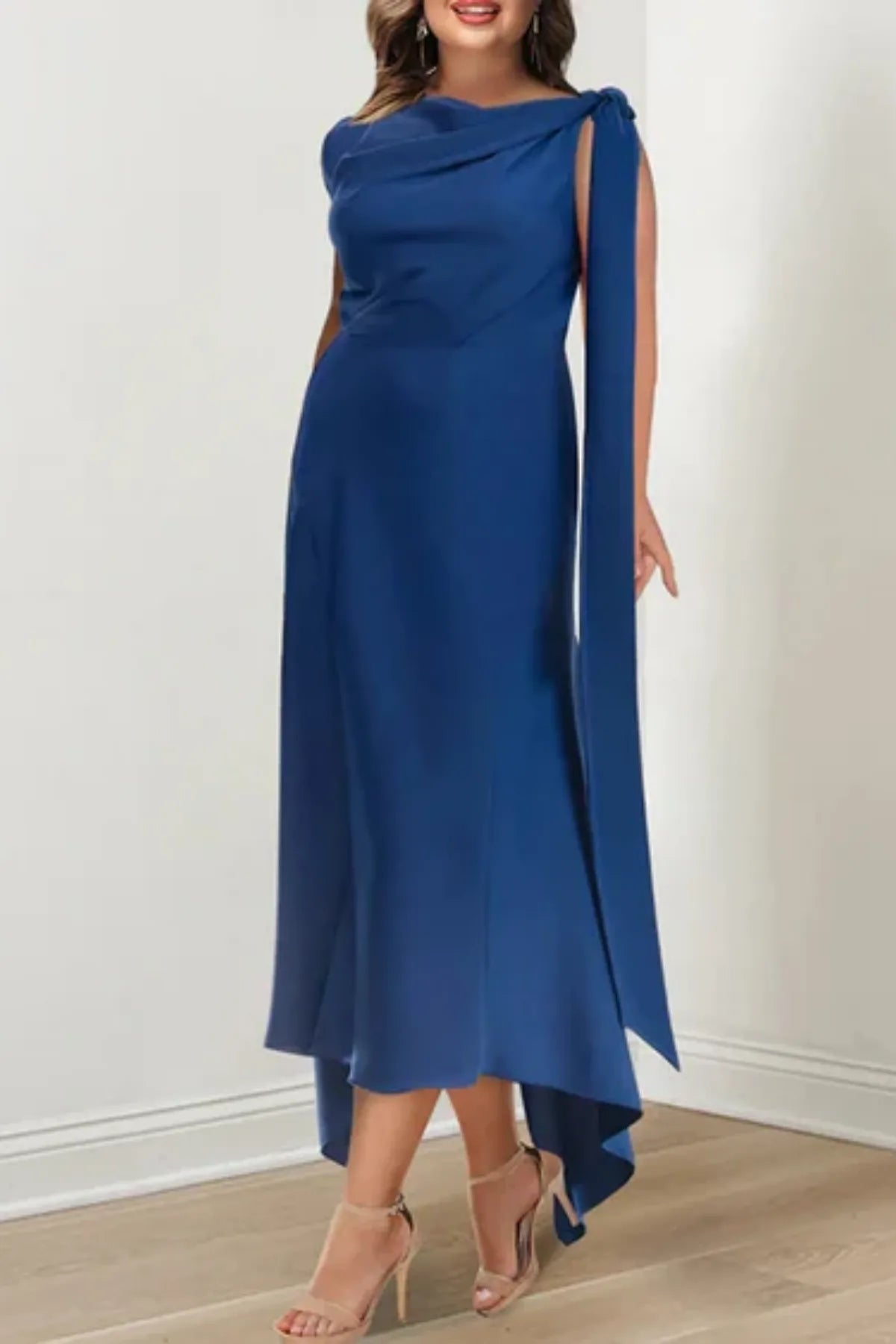 Front close-up of a structured navy blue formal dress bodice, showing a modest jewel neckline and defined waist gathering