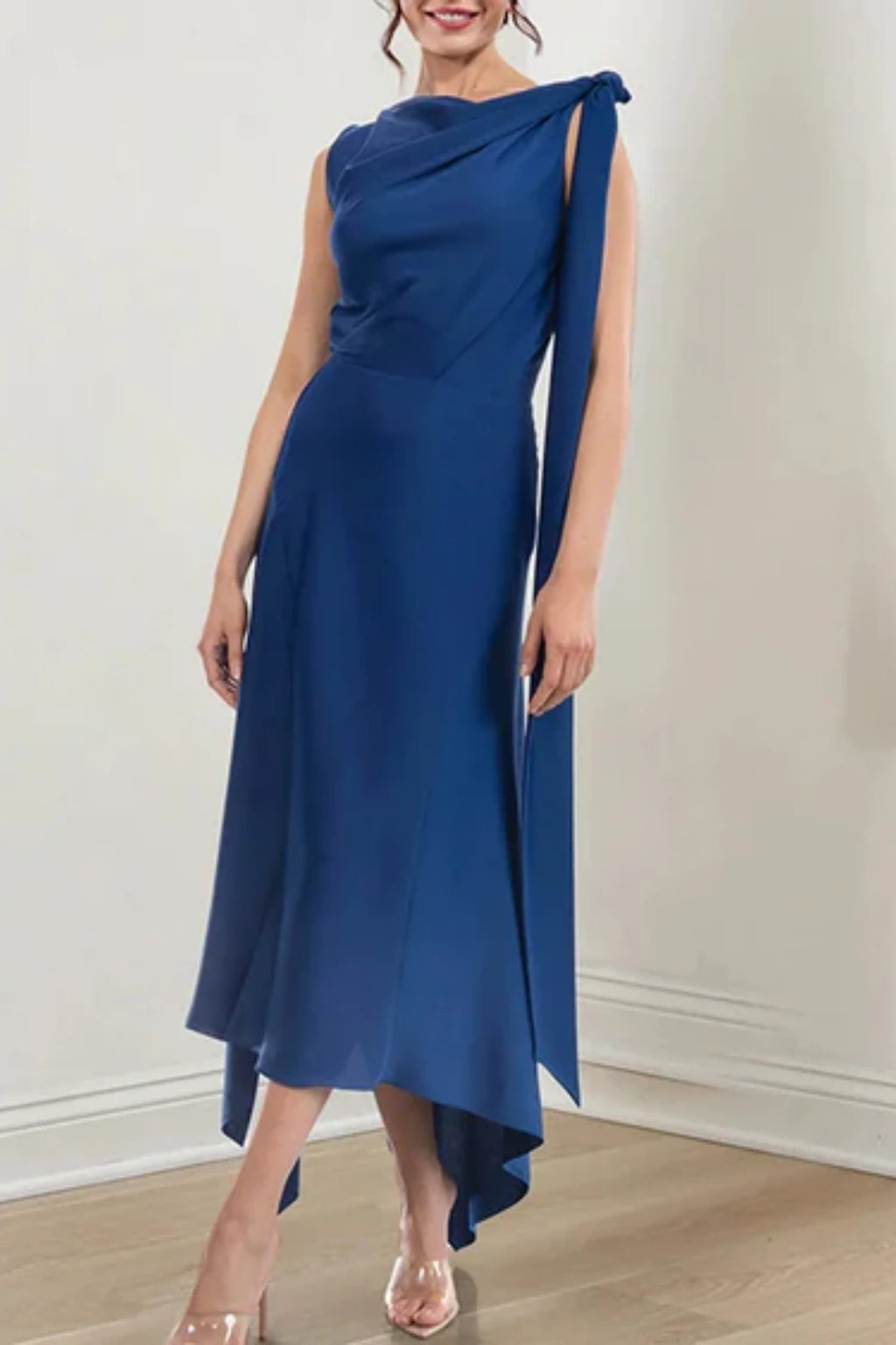 Side angle of a navy blue high-low formal dress on a mannequin, highlighting the cascading layers of the lightweight chiffon skirt