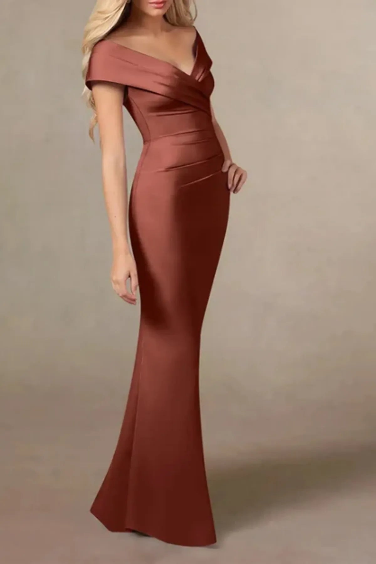 Close-up of the bodice on an auburn satin dress for mothers, showcasing the architectural overlapping pleats along the off-the-shoulder neckline