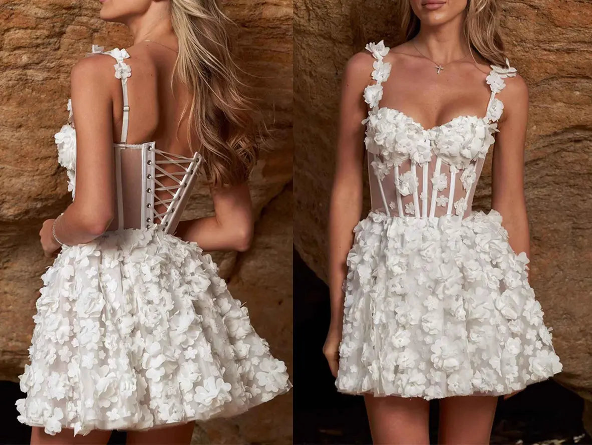 Rear view of a short wedding reception dress showing the adjustable lace-up back closure and flared organza skirt silhouette Rear view of a short wedding reception dress showing the adjustable lace-up back closure and flared organza skirt silhouette