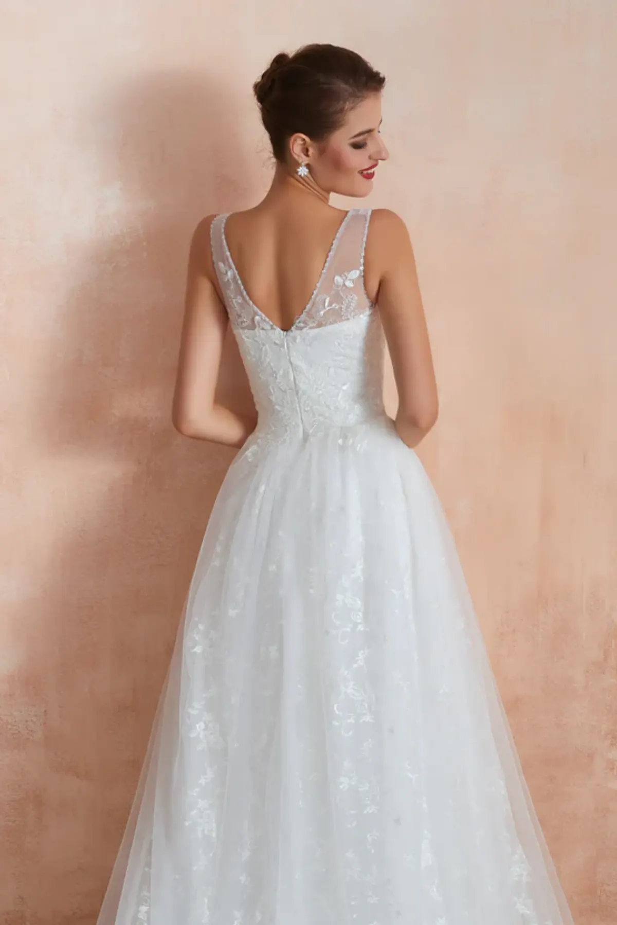 Close-up of sheer lace back detail on V-neck A-line bridal gown