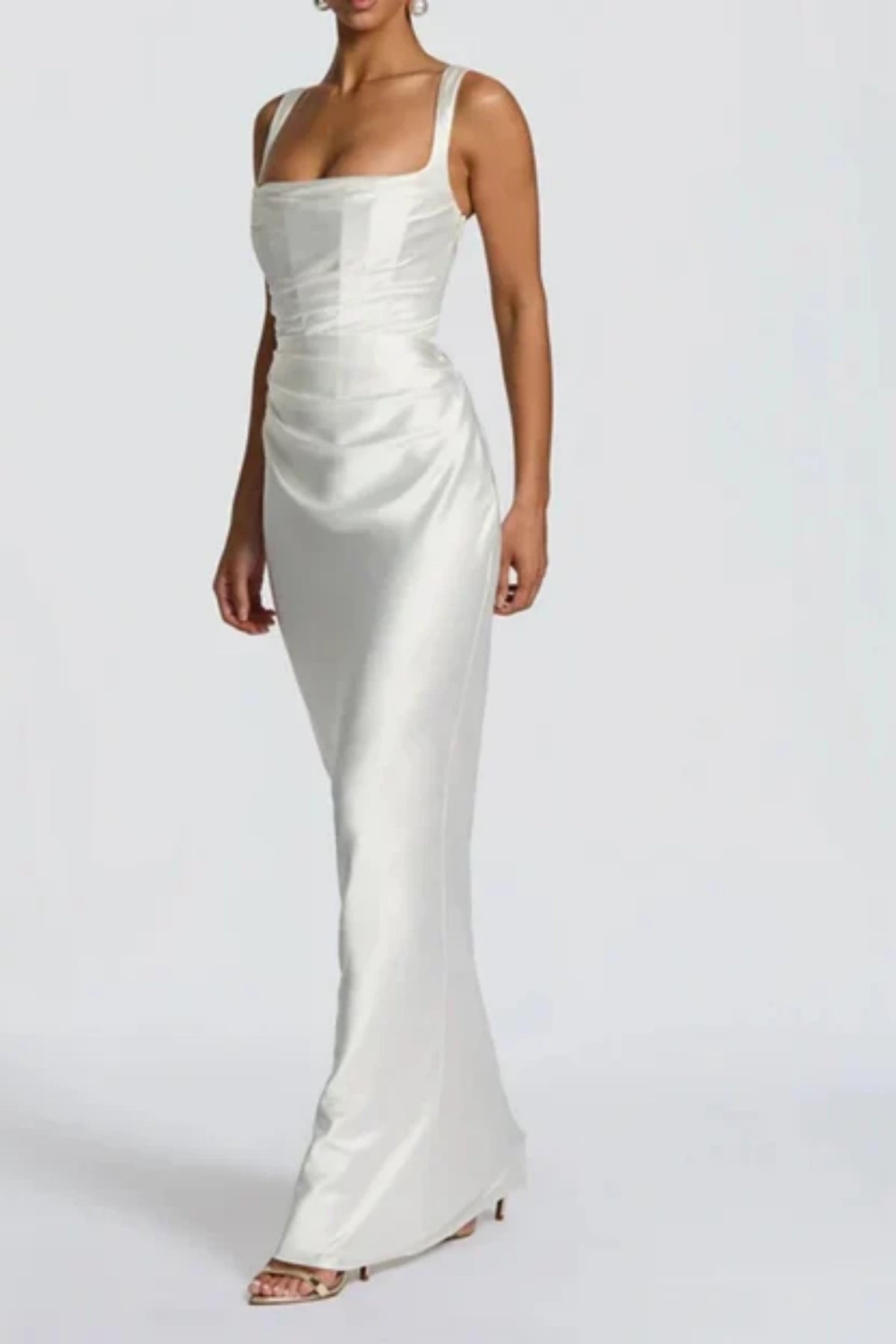 Elegant satin bridal gown with square neckline, structured corset and soft ruched skirt angled view