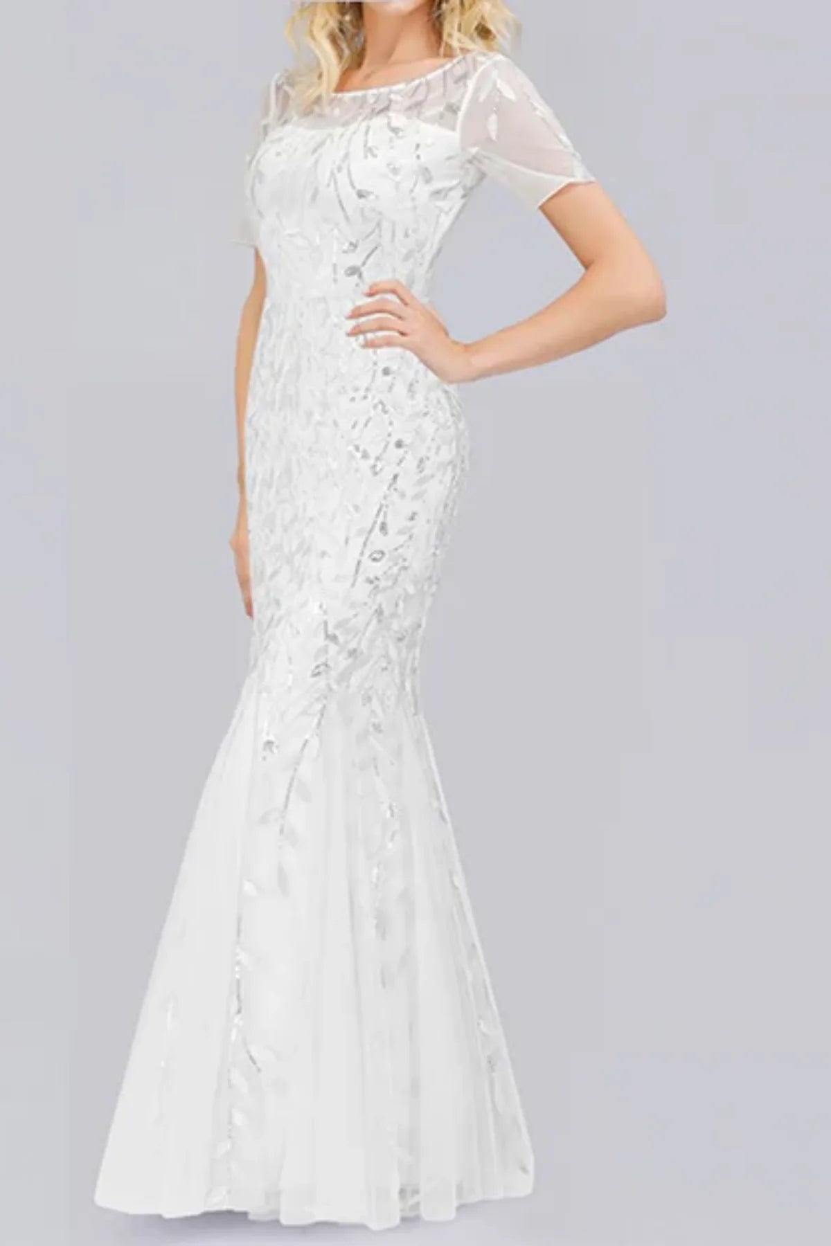 ull front view of a white long-sleeve mermaid wedding dress with an illusion V-neckline, covered in textured white leaf embroidery and sequins