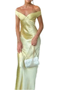 A yellow satin long dress with an off-the-shoulder neckline, a fitted sheath silhouette, and an open back.